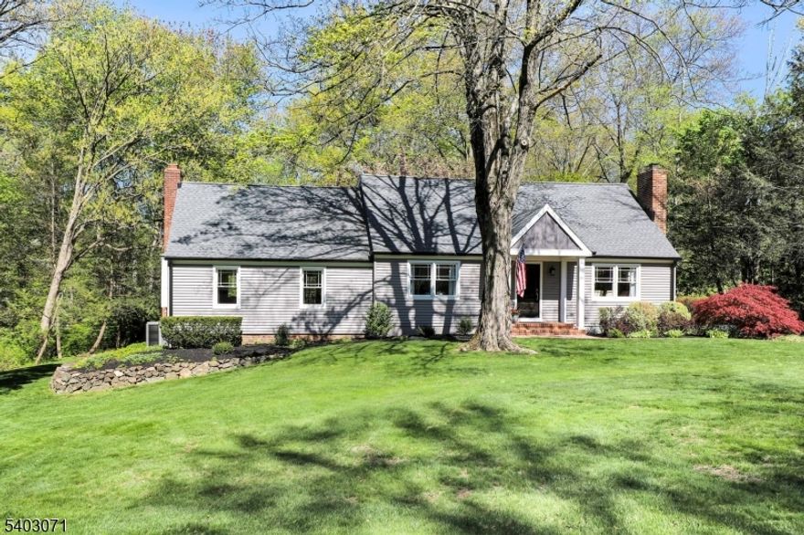 Step into this beautifully renovated, expanded cape situated on .73 acres. A charming brick walkway and new portico (2024) invite you into a home that perfectly blends modern convenience with luxurious design. The first floor features hardwood floors and custom moldings. The completely remodeled gourmet kitchen boasts quartzite countertops, an abundance of cabinetry, stainless steel appliances, and breakfast area. Host gatherings in the light-filled living room and dine in the formal dining room with wood-burning fireplace. The expansive family room with a wood-burning fireplace, custom built-ins, and wet bar is the ultimate spot for gatherings. A bedroom/office and full bath complete this floor. A large, private primary bedroom awaits upstairs, featuring a walk-in closet and a beautifully renovated en-suite bath. Finishing this level are two additional large bedrooms and full bath. The updated basement offers an enormous rec room ready to customize to suit your needs, plus a laundry area and storage room. Outside is a private oasis! A Trex deck spans the entire length of the house and overlooks the private, lush yard perfect for entertaining. Other upgrades include new siding (2022), new roof (2021), new windows (2022), and new hot water heater (2023). This home is minutes from quaint downtown Basking Ridge, a block from Lyons train station, and several blocks away from the elementary and high school. Don't miss the chance to own this meticulously updated gem!