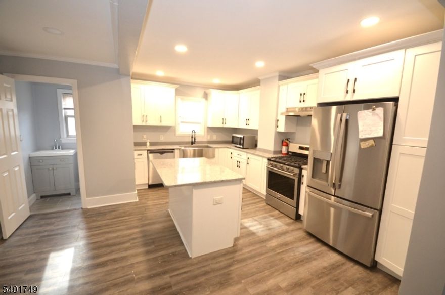 One Month Free Rent Option - GARWOOD: (CRANFORD, WESTFIELD AREA) MINS TO NYC!! Updated 4 bedrooms and 2.5 baths. Kitchen boasts quartz countertops, island, stainless steel appliances including gas range, dishwasher, refrigerator and open floor plan to living room. Unit offers an abundance of natural light, central air conditioning, led recessed lighting. Across the street from NYC Trains and few steps tp NJ Transit Buses. Close to shopping, gyms, restaurants and major highways. Pet friendly: up to 2 cats or small dogs permitted with fees.