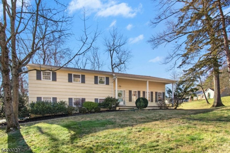 This spacious 4-bed, 3-bath split-level sits on a sunny .42-acre corner lot and offers flexible living for today's needs, including excellent MOTHER/DAUGHTER potential. Step inside to a dramatic great room with a cathedral ceiling and hardwood floors, opening directly to a private back terrace; an ideal setting for relaxing or entertaining. Just above, an elegant mezzanine-level formal dining room with hw floors overlooks the great room, creating a bright, open connection between the main living spaces. The eat-in kitchen sits adjacent and features a convenient secondary staircase leading down to the ground-level family room.The second floor featurs three bedrooms with hw floors and generous closet space, and two full baths, including a spacious primary en-suite. The ground level adds a fourth bedroom, full bath, family room, and a mud/laundry room with direct access to the garage and side entrance. A finished basement offers even more recreation and storage options. Outdoor highlights include an inviting front porch, rear terrace, and a large sun-filled side yard all minutes from the scenic Watchung Reservation. Discover exceptional living in highly desirable Mountainside, celebrated for its top-rated schools, including Deerfield, a Blue Ribbon School, and multiple commuting options just 22 miles from Manhattan.