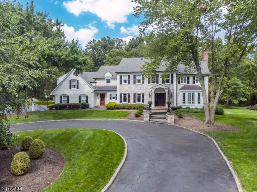 STUNNING COLONIAL SITUATED ON 4 PRIVATE ACRES. TASTEFUL, DESIGNER RENOVATIONS & UPGRADES MAKE THIS HOME MOVE IN READY. Nearly $1 mill in elegant upgrades. Simply perfect! Set 1,000 ft from the street, an impressive drive & stone pillar entry welcome you home! Fabulous moldings & millwork throughout including coffered ceiling & window seat; 3 masonry fireplaces, newer windows & roof, renovated kitchen and baths, newer HVAC & hot water heater, expansive blue stone patio w pergola overlooking level yard. Second level w 5 bedrooms, 3 full baths & includes a stunning master suite w fireplace, custom walk-in closet and luxurious bath! Finished lower level features media area, recreation area, full bath & ample storage. Copper gutters, upgraded landscaping, exterior lighting.  This home is a "wow"!!