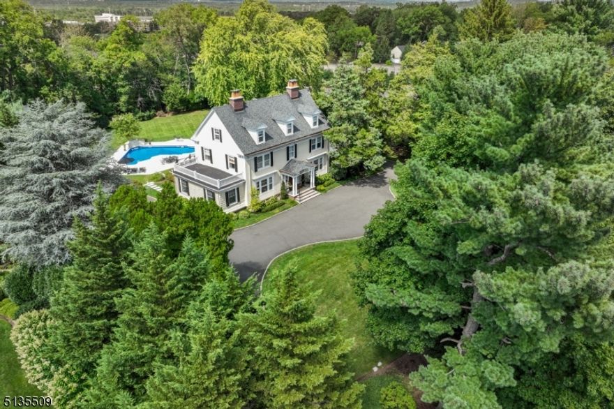 REFINED SUMMIT RETREAT on 1.57 acres. Stately and gracious 1905 Northside Colonial is distinguished in every aspect. Enter through the front door encased by original transom and sidelight windows to an inviting foyer. Original hardwood flooring, moldings, cabinetry, fireplace mantels and leaded glass windows have been retained and refinished. The gourmet kitchen with center island has a new WOLF 6-burner range. Breakfast area, dry bar and office open to an expansive Ipe deck overlooking a large, flat backyard with swimming pool/waterfalls/patio, all solar or LED lighted, and carriage house. An elegant wide staircase reaches the 2nd fl primary suite with bespoke 17'X11' dressing room and 2 bedrooms plus hall bath. The 3rd fl offers 3 bedrooms, full bath and cedar closet. The renovated walkout lower level provides more office space, exercise room with ballet barre, a 2nd family room, full bath, laundry, mud room with large cubbies, an oversized 2-car garage plus a heated and cooled storage room. BONUS SPACE: BEAUTIFUL, LARGE 2-STORY UNFINISHED CARRIAGE HOUSE has unconnected electricity. A private retreat with CONVENIENT LOCATION. Easy access to all that Summit offers: NYC transportation, outstanding public and private schools, a jazzy dining and shopping scene, recreation, The Short Hills Mall, Canoe Brook Country Club and a quick drive to Newark's International Liberty Airport.