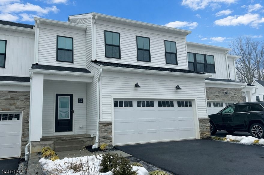 Brand-new 2025 Toll Brothers townhome for rent in the highly sought-after Oaks at Randolph community. This spacious and thoughtfully designed home features an open foyer leading to a sun-filled great room and dining area with direct access to the backyard. The modern kitchen offers a center island with breakfast bar, quartz countertops, ample cabinetry, and a walk-in pantry. Appliances include refrigerator, microwave, and in-unit washer and dryer. The second floor features three bedrooms, two full baths, a powder room, loft area, and laundry. The primary bedroom suite includes a walk-in closet and a luxurious bath with dual-sink vanity, shower, and private water closet. One additional bedroom also offers a walk-in closet. Finished basement provides flexible space for entertaining, recreation, or play and includes an additional powder room. Hardwood flooring throughout the main and upper levels, with durable LVP flooring in the basement. Additional storage throughout. Conveniently located near shopping, dining, and major commuter routes.