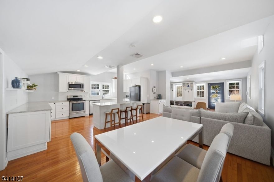 Welcome to this exceptional home in the highly sought after Cedar Lake community of Denville, where lake living meets small town charm. Nestled on a quiet cul-de-sac, this impressive 4 bdrm PLUS office, 4 bath residence offers over 3K sqft of living space across 3 finished levels, delivering the perfect blend of comfort, style, & functionality. Located w/in walking distance to the Lake, enjoy year round rec including swimming, kayaking, fishing & community events. As part of CL, residents benefit from private lake access & a true neighborhood feel. Just mins away, vibrant DWTN offers boutique shopping, top rated restaurants, coffee shops, brewery, parks, & NJ Transit, making this one of Morris County's most desirable towns. Inside, a stunning open concept showcases a chef's kitchen w/SS appliances, granite countertops, HW flooring, a large center island, soaring ceilings & abundant natural light. All 4 baths are beautifully renovated. 2 bdrms are conveniently located on the main level, w/2 addtl bdrms on the ground level. Expansive living areas across the 3 levels, offers incredible flexibility. Outdoor living shines w/a spacious deck, yard & Rainbow play-set (included). A storage shed & ample off-street parking add convenience. Addtl highlights include multi-zone heating & cooling, newer central air (5 years), new water softener, new rear roof &roof, 40-amp Level 2 EV charger, & whole-house gen hookup. Public water &sewer