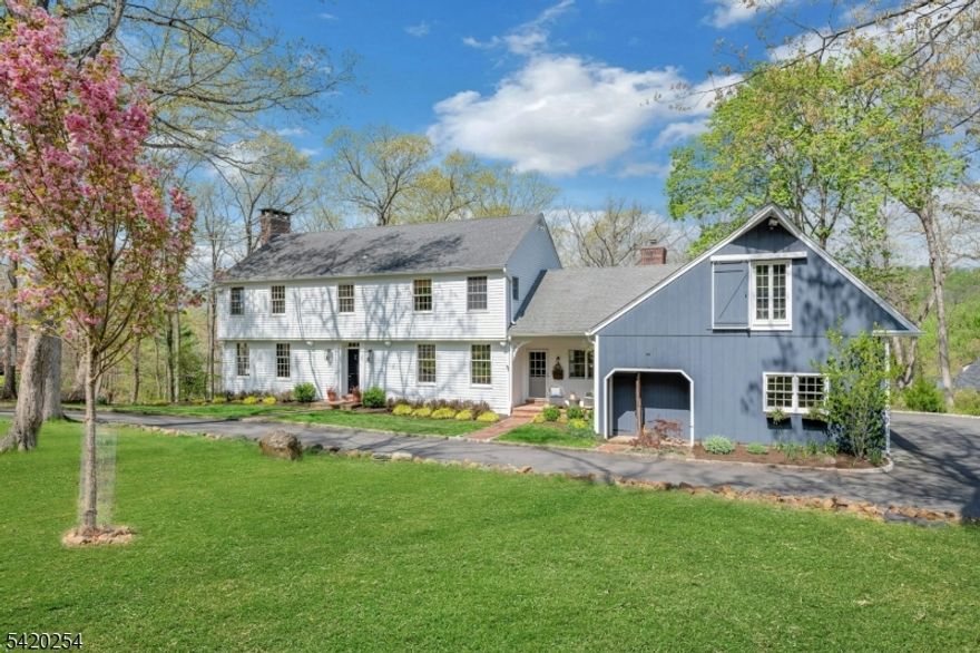 Classic, custom colonial set on private cul de sac lot welcomes you home! Vintage charm, custom features and current updates combine in offering this select property. The welcoming front foyer with a richly carved entry leads to a front to back living room infused with natural light and centers around a large gas fireplace. The heart of the home reveals a full kitchen makeover with chef grade appliances and opens to a large dining area surrounded by windows, family room and second fireplace. An inviting sitting nook greets you at the side entrance. The home features hardwood floors throughout both levels. The second floor can be accessed from the main or rear staircase. Four generous bedrooms include a light filled front to back primary bedroom with completely renovated primary bath and oversized walk-in closet. The main bath is newly renovated as well. The second story walkway which overlooks the family room and kitchen leads to the fourth bedroom and adjoining office/media room. A fully finished ground level provides an optimal layout for guests: 5th bedroom, full bath, kitchenette, large recreation, mudroom and separate entrance with an additional 3 car garage. Enjoy the peaceful & private property from both the main and ground floor stone patios.  The interiors are freshly painted, exterior professionally landscaped and circular driveway newly resurfaced. Top rated Watchung Hills HS and minutes from Rts. 22 & 78 within minutes to Newark airport.