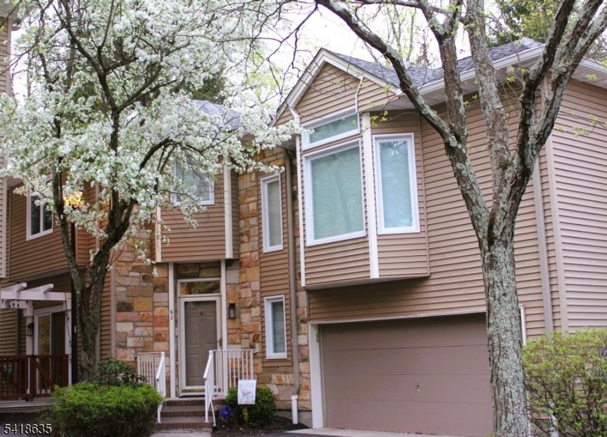 Rare largest model townhouse in a highly sought-after NYC commuter community, offering exceptional space, privacy and flexibility for hybrid-work lifestyles. Set on a quiet cul-de-sac with a wooded backdrop, easy access to bus, train, and major highways, under an hour from NYC. This move-in-ready home features 3 bedrooms plus 2 bonus rooms, finished basement, and large 2-car garage, ideal for home offices, guest suites, gym, or play area. Thoughtfully designed with abundant storage, including closet space and built-in shelving throughout, including the garage.The first floor offers light-filled living spaces highlighted by a vaulted living room with skylight and wood-burning fireplace, premium red oak hardwood floors, and flexible family and recreation areas. Renovated open-concept kitchen with quartz countertops, ForeverMark cabinetry, and stainless steel appliances, flowing to the dining area and private deck with gas line. Upstairs, the airy primary suite includes multiple closets and an updated en-suite bath with soaking tub. Two additional large bedrooms share an upgraded skylit bath, plus bonus space with ideal for guests or office. Finished basement provides rec room, laundry, and third bonus room with closet for office or au pair space. Highlights include custom blinds, updated HVAC, whole-house water filtration, and recent roof, windows, skylights, and patio doors with internal blinds. Close to nationally recognized schools, parks, shopping, and daily conveniences.