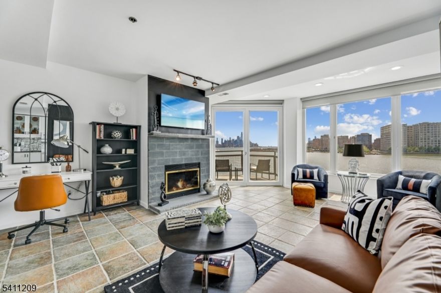 A commuter's dream meets luxurious living!  Welcome to Riva Pointe! Perched along the Gold Coast waterfront, this exquisite apartment offers sweeping Hudson River and skyline views that dazzle, especially at sunset, best enjoyed from your private balcony.  Every detail inside has been curated for modern living. Cozy up by the wood-burning fireplace, prepare meals on sleek granite countertops, or unwind in the newly renovated powder room and spa-like primary bathroom. Sunlight floods through large windows, illuminating the open dining area, while the in-unit washer/dryer provides convenient access.  This full-service building elevates amenities: 24-hour concierge, elevator, free assigned covered garage parking, a state-of-the-art gym with sauna, sun decks, landscaped terraces, private storage, and a heated indoor pool. Importantly, the residence offers gated entry, video surveillance, and outdoor common areas for 247 lucky residences. Step outside, and you're just moments from Whole Foods, Ruth's Chris Steakhouse, boutique shopping, and vibrant dining options. And for commuters? The Lincoln Harbor ferry is only a short distance away, whisking you to Midtown Manhattan in a speedy 8 minutes.  This unique building extends 1,000 into the river and is surrounded  by water on 3 sides. Don't let this one-of-a-kind home pass you by, schedule your tour today!