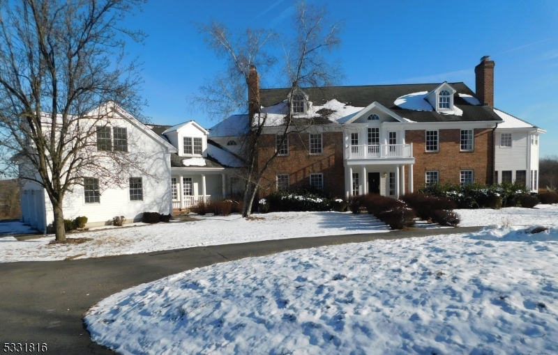 Stately Georgian Center Hall Colonial set on the rolling hills of Hunterdon County overlooking the mountains of Tewksbury. A one-of-a-kind estate home sitting on a private 4.5 acres lot. Over 7200 Sq.Ft of living space with 4 on suite bedrooms on the second floor, in-law or au pair suite with it own kitchen on the lower level.  Features include a cherry paneled library, five fireplaces, hardwood floors throughout, panoramic floor to ceiling windows in the great room, massive master suite with oversized bathroom, two walk-in closets and a sitting room. Other features include a walkout finished basement, 3 car garage, 2 whole house generators, 6 HVAC units and so much more. Property is bank owned and is selling as is only.  Buyer is responsible for any required inspections by city, town, county or state requirements, including the CO.