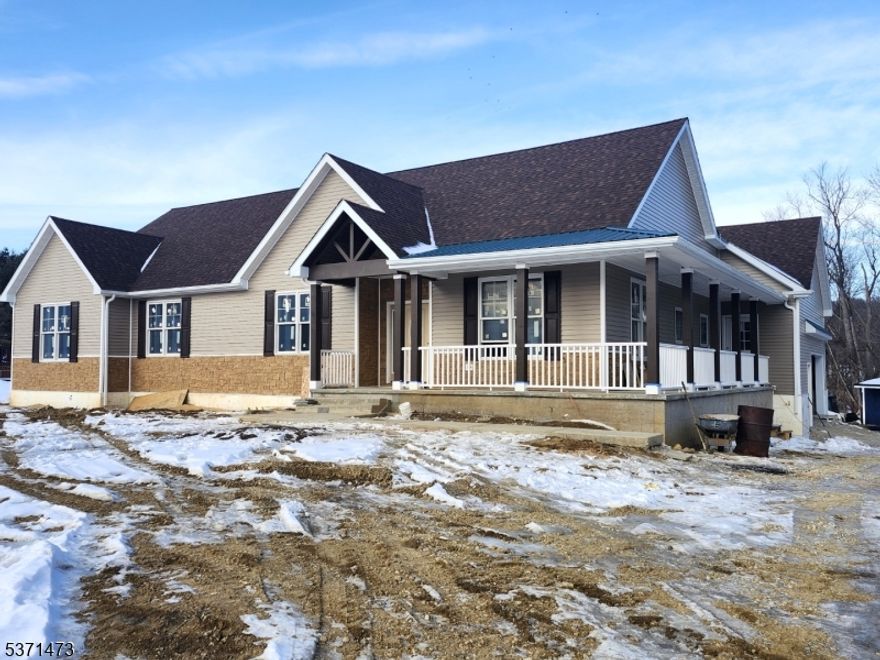 Custom 3300 S.F home is  nestled on .68 acres bordering preserved land.  . The Master bedroom and the Great room each have 16 x 10' decks to enjoy the mountain views.  A huge wrap-around porch offers the perfect place to relax and enjoy the summer breezes. A massive stone fireplace  adorns the 20 x 18 Great rm to warm those chilly nights   This breathtaking home offers hardwood flooring throughout and a large cathedral ceiling adds to  the WOW factor.  The 18 x 14 Primary bedroom has a 16 x 11 bath with shower plus sauna and two 8 x 8 walk-in closets.  The kitchen. offers granite countertops, SS appliances. a walk-in 14x7 pantry, and a large center island to satisfy any gourmet cook.  There is also a first floor laundry/mud room for your convenience. The huge basement has double doors leading to the back yard.  Home was built with R28 insulation for extra utility efficiency.  There is pre-plumbing put in the basement floor for any future finishing and addition of a  bathroom.  Completion time  would be approximately 1-2 months. Desirable natuural gas heat is possible. Don't miss out on this opportunity.