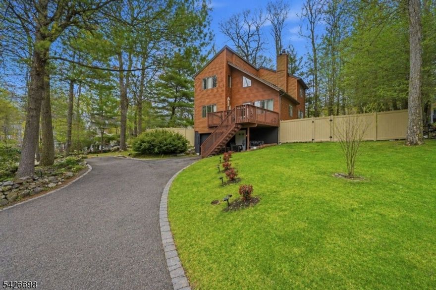 Welcome to this spectacular unique style home that stands out from the rest. You will love the abundance of natural light  and the wow factor that comes from the skylights and the high ceilings of the living room.  The living room flows into the newly renovated kitchen complete with black granite waterfall style countertop. Enjoy casual eating at the counter top bar or in the dining room with views of the established pines. An extra large bedroom and full bath complete the first floor. On the second floor enjoy the view from the loft area, large enough for a bedroom and an office. Relax in the large master bedroom  with double closets, and great views. The second floor bath is amply sized and contains a dedicated laundry area.  On the ground level you have a storage room with lots of potential.  An extra dedicated parking space out front can be used for a car or boat. The home also has a new roof for peace of mind.  Enjoy gorgeous sunsets on the elevated deck and cozy nights by the fire pit in the leveled back yard perfect for barbecues. Walking distance to the lake beach area you can enjoy swimming, fishing, boating, fireworks festival and winter skating. optional affordable, lake membership. The home also comes with your own personal dock(must apply for this).  Minutes to restaurants, farms, apple picking, and shops. Enjoy all that this gorgeous home has to offer and the fun and relaxed community of upper greenwood lake.