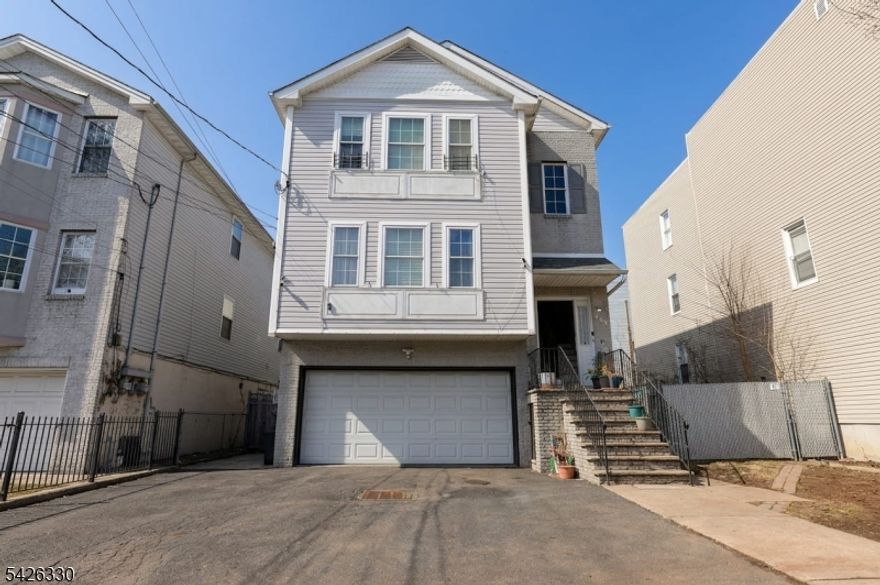 Well-maintained and spacious two-family home with a bonus unit. Thoughtfully designed for flexible living arrangements. This property offers 6 bedrooms and 5 full bathrooms across multiple levels. The first unit is a duplex featuring 3 bedrooms and 2 full bathrooms on the main level, including a primary bedroom with an en-suite bath. The lower level includes two bonus rooms, 1 bath with a full kitchen, and a separate entrance, offering versatile living space. The second unit consists of 3 bedrooms and 2 full bathrooms, providing comfortable accommodations. This layout is flexible for a range of living arrangements, including owner-occupancy, with extra space for extended household use or to generate supplemental income to offset monthly mortgage payments. The home includes central air conditioning and central heating, along with a mix of hardwood and tile flooring throughout, and equipped kitchens with dishwashers. Additional highlights include a private backyard, a two-car garage, and a driveway accommodating up to 4 vehicles. Conveniently located near major highways, public transportation, schools, shopping, and parks. Buyer Note: Various financing options may be available to qualified buyers, including programs offering competitive rates and potential down payment or closing cost assistance.