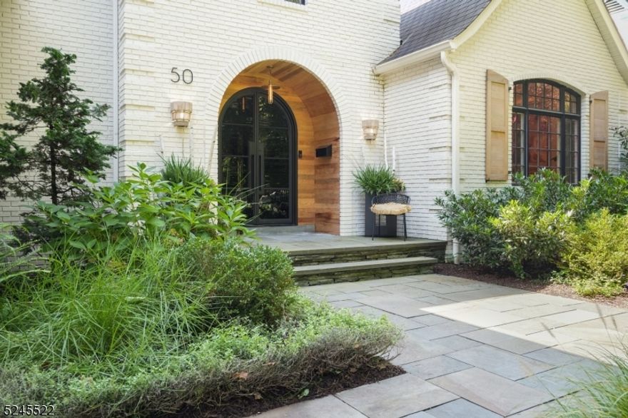 Exquisite luxury home nestled on a quiet, wooded street in the heart of the desirable Hill section of Madison. Bespoke finishes, modern amenities and incredible space combine in this one-of-a-kind property. An arched iron front door opens to light-filled living spaces with pickled oak plank flooring, architectural millwork and a color-drenched color palette. The dreamy kitchen features high ceilings with oversized lighting, a large quartz-topped weathered oak island, custom banquette seating area, professional appliances by Viking, Miele and GE Cafe, Missoni wall accents, and an antique mirrored backsplash. A formal dining room, living room, cozy family room, clever office & stunning powder room complete this level. The primary suite boasts custom Schumacher window treatments, ensuite bath with marble-topped vanities, soaking tub, steam shower with jets, and custom built-in and walk-in closet storage. Hall bedrooms feature hardwood floors under custom carpet and California closets, with two full baths, 2nd floor laundry center and linen storage nearby. Downstairs, find recreation, exercise, office and guest space, plus a 2nd laundry room, all with exceptionally high ceilings. Outside gorgeous grounds are framed by mature trees and specimen plantings. A bluestone patio and new playset are ready to enjoy, with a 'secret' entry to the nearby schoolyard. Blue ribbon schools, vibrant downtown Madison, commuter trains to NYC and the Loantaka trail system are all within easy reach!