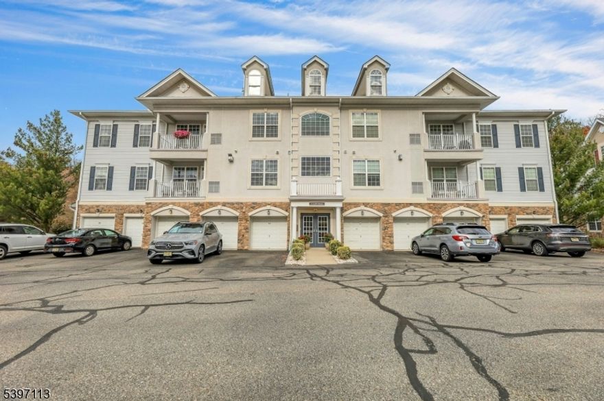 Welcome to 4 Seasons at Great Notch, a vibrant 55+ gated community! "Magnolia" 2-bedroom, 2 bath unit located on the 2nd floor in an elevatored building with a fabulous view of Rifle Camp Park off the balcony! This well-kept home has approx 1,750 sq ft of living space, a built-in private 1-car garage with storage room and parking space! Living/Dining room combo with gas fireplace and door leading to a spacious balcony, gourmet kitchen with double oven, gas range, dishwasher, microwave & refrigerator. Granite counter tops, breakfast nook, spacious den, laundry room, 2 bedrooms & 2 tiled baths (Primary King-size bedroom has a walk-in closet, full bath with double sink, shower stall, and jetted soaking tub.  Hardwood flooring in the living area, wall-to-wall carpet in bedrooms. Pet-friendly, maximum of 2 pets, no breed restrictions. Gas forced air heat, gas water heater, and central AC. Maintenance fee of $529 includes amenities such as: clubhouse with gym, indoor & outdoor pool, card room, ballroom, billiards, bocce, tennis & pickleball courts, putting green, and more! Conveniently located near major roads.