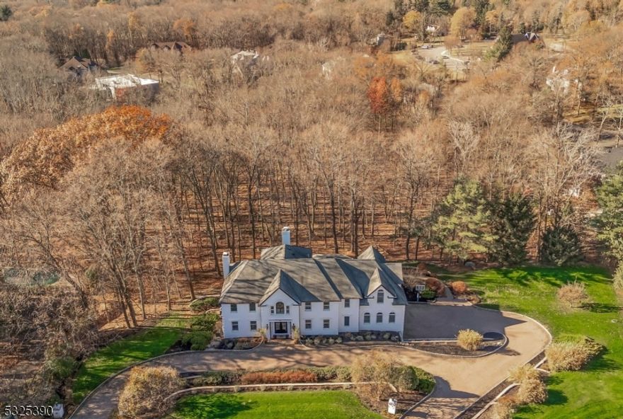 766 Jenny offers the modern edgy vibe of today's current design merged with timeless elements of a traditional center hall colonial. The wrought iron double door front entry introduces a floating staircase atop a porcelain-tiled floor that showcases the dramatic 2-story space. The east-facing orientation along with walls of windows, light oak floors, and white walls accentuate the natural light that floods the home. The breathtaking kitchen boasts quartz counters and mirrored cabinetry with brass accents. The breakfast room with shiplap ceiling offers unobstructed views of endless woodlands and opens to the great room and family room for effortless entertaining. A sleek wet bar and chic lounge, wrapped in luxurious Gucci wallpaper, add a sultry, modern touch. Upstairs find the primary with fireplace, two walk-in closets, and a new porcelain bath. Three more bedrooms and two baths complete the second floor. The walk-out Lower Level is perfect for guests with an ensuite bedroom, kitchen, family room with fireplace, gym, laundry, and 3 car garage. This private oasis abuts acres of woodlands! What a gem!