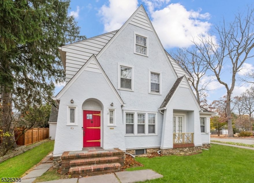 Step into this enchanting English-style Tudor home, a masterpiece of timeless elegance & exceptional care. From the moment you enter, the rich walnut wood floors & intricate solid wood moldings set the tone for a home that exudes warmth & sophistication. The living room is a cozy haven w/a stunning wood burning fireplace, perfect for gathering on chilly evenings. An arched opening leads to the formal dining room and eat-in kitchen, creating a seamless flow that's ideal for entertaining. Adjacent to the main living spaces, you'll find a sunroom currently used as an office & a serene screened-in patio w/flagstone flooring, offering the perfect retreat. A 1/2 bath complete this level. The 2nd level hosts all bedrooms w/rich wood floors including a generous primary w/2 cedar closets &  a full bath w/subway tile & tub/shower. The lower level boasts a rec-room w/a 2nd fireplace & charming fieldstone walls, creating a warm and inviting space. The freshly painted exterior enhances the home's curb appeal, while the detached 2-car garage w/an expansive loft provides ample storage & potential for a workshop or creative space. Throughout the home, architectural details such as the handcrafted moldings & arched openings reflect the elegance & character of its style. This beautifully maintained home is a rare find, offering a perfect blend of historic charm & comfort. Set on the corner of 2 dead end streets, this move-in ready gem offers a tranquil setting & unparalleled craftsmanship.