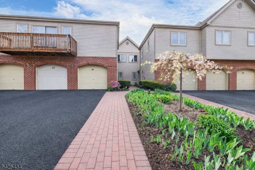 This home features an inviting approach with an Iris garden leading to a well-manicured, landscaped paver entranceway, with the garage exiting into a private covered vestibule for added privacy. Inside, the layout offers multiple living areas and good natural light throughout. The eat-in kitchen provides ample cabinet space and room for a dining table, while the main living area is a combined living room/dining room. Bedrooms are well-sized, including a primary bedroom with a full bath and vaulted ceilings. There is also a main bathroom on the second floor to accommodate additional bedrooms. Bathrooms are clean and neutral. The interior is freshly painted with neutral tones, carpets have been cleaned, and the home is ready for quick delivery. Outdoor amenities include access to a nearby in-ground pool, tennis court, and clubhouse just a short walk away offering additional space for recreation and entertaining. Hanover Township features highly rated schools, a low tax rate, and is conveniently located near major highways, shopping centers, and restaurants, providing easy access for commuting and everyday needs. Photos are virtually staged.