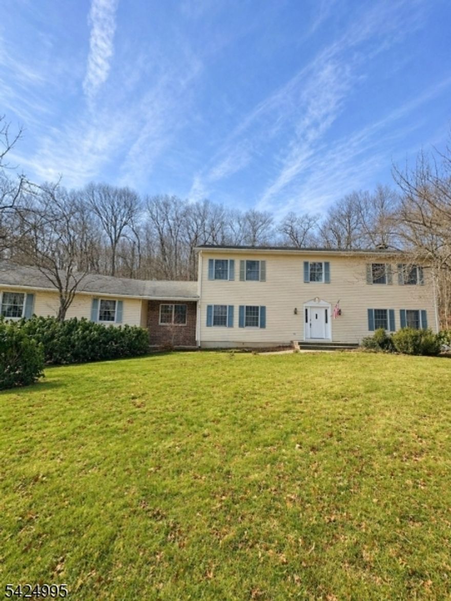 Escape to your own private 3-acre sanctuary at 611 Snake Den Road; an elegantly renovated retreat surrounded by nature, yet moments from the conveniences of West Milford. This beautifully updated 4-bedroom home features a brand-new 4-bedroom septic system, a high-end designer kitchen with quartz counters and premium appliances, and two fully renovated bathrooms with modern finishes. The main level offers generous living and dining spaces, perfect for entertaining, along with access to a spacious back deck ideal for outdoor dining, gatherings overlooking your private landscape. A large screened-in porch provides year-round enjoyment and an effortless indoor-outdoor lifestyle. Upstairs, four comfortable bedrooms offer flexible living options, and the full lower level with high ceilings has a second stair leading directly to the garage and provides additional opportunities to customize and storage space. The oversized 2-car garage and long private driveway add convenience and privacy. With 3 peaceful acres, stunning natural surroundings, a completely refreshed interior, and major upgrades already completed, this move-in-ready home is the perfect blend of luxury, comfort, and mountain living.