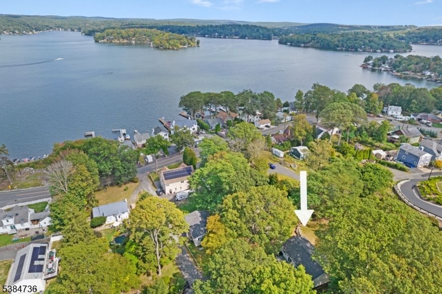 Welcome to 18 Sutton Road in the desirable Sperry Springs section of Lake Hopatcong! This 4-bedroom, 2-bath raised ranch blends modern updates with true lake living. Enjoy deeded lake access plus the option for a private boat slip (additional cost), offering the perfect way to experience New Jersey's largest lake. Set on a private tree-lined lot with seasonal lake views, the home features luxury vinyl plank flooring in all bedrooms (2025), a brand-new roof (2025), updated lighting in the laundry/utility room with washer & dryer included, and a kitchen with stainless steel refrigerator and stove. The open-concept second floor includes the kitchen, dining, and living areas flowing to the deck through sliding glass doors. The primary suite offers double closets, a private bath, and deck access, while two additional bedrooms and a full bath complete this level.The lower level includes a converted garage offering flexible living space that can serve as a den, office, or game room, with the option to convert back if desired. An additional 4th bedroom and spacious family room complete this floor. Natural gas service is anticipated in the area by 2029, per Hopatcong's zoning map. Live the lake life with boating, fishing, dining, and recreation right at your doorstep!