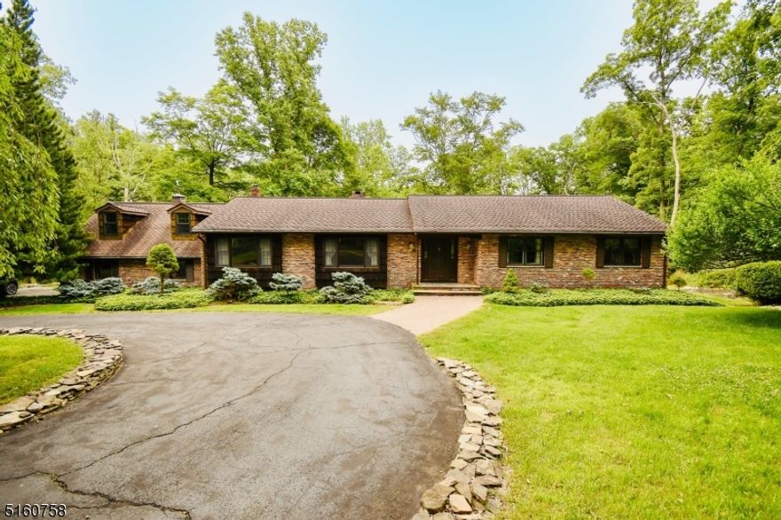 Situated on over 4 acres of tranquility at the end of a private road, this solid, all brick expanded ranch features a great floor plan, huge living room and formal dining area, a beautiful brick fireplace and hardwood floors. The enclosed 3 season room off the kitchen overlooks the park like backyard.  Bonus room above the garage can be a guest bedroom or office. Generous 2 car garage and paved circular driveway make for convenience.  See it today.