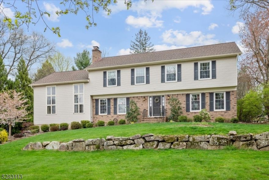 Elegant Colonial in a Peaceful Neighborhood! This graceful 4 bedroom, 2.5 bath home is set on just over half an acre of landscaped property on a tree-lined street in Randolph with top-rated schools and close proximity to shopping, dining, parks and highways. Past a stately front entry, you'll find rich hardwood floors and architectural details throughout the main level. Flanking the foyer are a spacious formal living room and a gorgeous eat-in kitchen equipped with classic white cabinets, ample granite counters, subway tile backsplash, stainless steel appliances and contrasting center island with seating. A dual-sided gas fireplace can be enjoyed in the generous breakfast nook or the incredible adjacent family room boasting a vaulted ceiling with skylights and French doors to a large deck and sprawling flat backyard beyond for effortless indoor/outdoor entertaining. The beautiful formal dining room boasts a tray ceiling and chair rail detail, and a handy main-floor laundry and a powder room complete this level.  An oversized primary suite awaits you upstairs, including a huge bedroom with adjoining loft overlooking the family room as well as a walk-in closet and private bath with shower. Three more big bedrooms share use of a full hall bath with dual storage vanity and tub with shower. The full finished basement offers additional living space, housing a rec room, separate sitting room, access to the attached 2-car garage, and abundant space for storage.