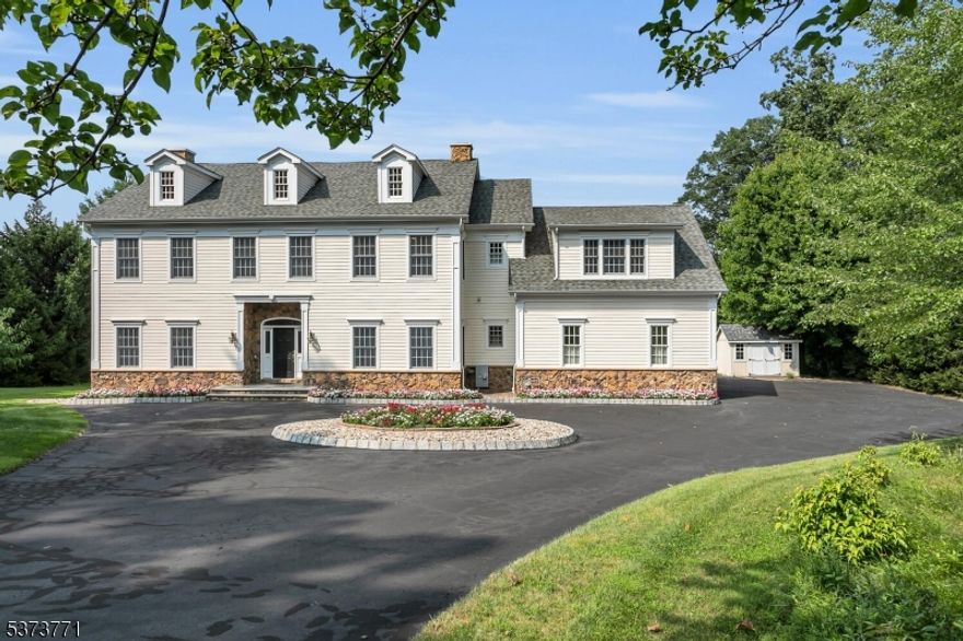 Nestled on nearly 5 acres of private, park-like grounds in Basking Ridge, this stunning colonial offers over 5,000 sq. ft. of luxurious living space. Step into the foyer and discover a thoughtfully designed 1st floor featuring a spacious family room with floor-to-ceiling stone wood-burning fireplace (with gas insert), elegant dining room, office, living room, mudroom, powder room, and additional full bathroom. The gourmet kitchen is a chef's dream, boasting a large center island, granite countertops, custom off-white cabinetry, and premium stainless-steel appliances. The sun-drenched breakfast room with wrap-around windows opens to a recently upgraded deck, offering views of the expansive yard, complete with tennis and basketball court. The 2nd floor offers 5 generously sized bedrooms, 4 full baths, and laundry area. The luxurious primary suite is complete with a spacious sitting room/office, spa-like bathroom with jetted tub, separate shower, and 2 walk-in closets. The finished basement has a rec area, kitchenette/bar with sink and full-sized refrigerator, workout room, full bathroom, and ample storage in a large utility room. Some additional upgrades include a Generac Generator 2013, new water heater 2018, exterior painted 2019, new gutters 2019, new composite decking 2022, new HVAC 2023, and steam humidifier 2025. This exceptional home is just minutes from shopping, restaurants, and transportation in a top-rated Basking Ridge school district.