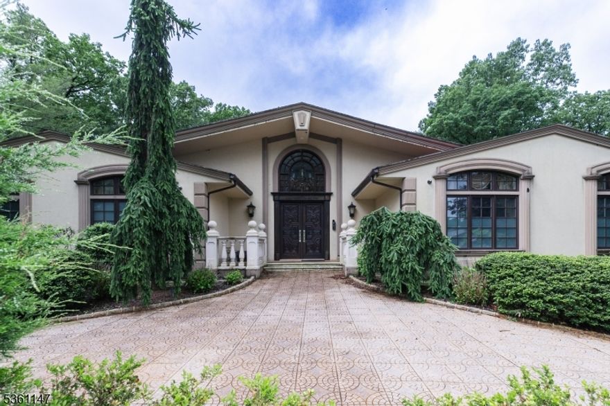 This stunning 5-bedroom, 5.5-bathroom home is a perfect blend of luxury and comfort, thoughtfully crafted with high-end finishes throughout. Custom light fixtures add a unique, elegant touch to every room, while premium flooring from rich hardwood to designer tile enhances the home's sophisticated design. The property features a spacious finished basement and a private home theater, ideal for entertaining or relaxing. Outdoors, enjoy a resort-style heated in-ground pool surrounded by beautifully landscaped grounds, creating your own private oasis. Inside, the high ceilings and large windows offer an abundance of natural light, highlighting the home's modern layout and open-concept flow. The kitchen is a focal point, ideal for entertaining, with sleek fixtures that complement the contemporary aesthetic. Located in a quiet, tree-lined neighborhood with convenient access to top-rated schools and commuter routes, this home truly offers exceptional living in one of New Jersey's most sought-after towns.