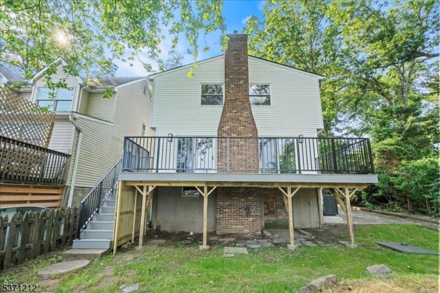 Welcome to this stunning custom lakefront home offering serene water views and a peaceful natural setting. This 3 bedroom, 2 bathroom residence boasts hardwood flooring and recessed lighting throughout, creating a warm and inviting ambiance in every room. Enjoy cozy evenings in the spacious living room with a charming wood burning fireplace, or cook up your favorite meals in the eat in kitchen featuring stainless steel appliances. The primary suite offers a walk in closet and an en suite bath complete with a soaking tub and stall shower. Skylights in the bedrooms bathe the rooms in natural light. A versatile bonus room provides the perfect space for a home office, hobby room, or guest retreat, giving you even more flexibility to suit your lifestyle. Step outside onto the deck overlooking the tranquil lake, perfect for morning coffee or sunset relaxation. The full unfinished walkout basement provides excellent storage or future living space potential, and a generous driveway offers ample parking for guests. Just minutes to Wawayanda State Park, the Appalachian Trail, downtown Warwick, local wineries, a drive in theater, and more. This is lakeside living at its best whether you're entertaining, relaxing, or exploring the outdoors, this home provides the perfect backdrop for it all.