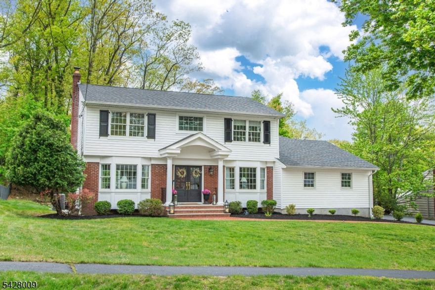 Ideally located in town, this beautifully renovated Colonial has been taken down to the studs and thoughtfully rebuilt with exceptional quality and design. Updates include new siding, a three-year-young roof, all new Andersen windows, upgraded insulation and sheetrock, newer oak flooring, and all new interior and exterior doors. A 545 sq. ft. rear addition enhances the living space, creating an impressive family room with a vaulted wood-beam ceiling and gas fireplace with custom mantle. The kitchen is a true centerpiece, featuring high-end JennAir appliances, dual ovens, custom hood, pot filler, under-cabinet lighting, a walk-in pantry, and an expansive 10-foot center island, all open to the stunning 14-foot cathedral ceiling family room. The main level also offers an inviting foyer, private home office with French doors, and a spacious front-to-back living room. Upstairs, three well-appointed bedrooms include a luxurious primary suite with a custom walk-in closet and spa-inspired bath with soaking tub and separate shower. Additional highlights include brand new plumbing and electrical, recessed lighting, Cat5 wiring throughout, Ring security system, and a garage with new doors and epoxy flooring. The full unfinished basement offers excellent storage and future potential. Set on a flat, level lot on a quiet street, just steps from Memorial Park and Washington School this home offers exceptional location, quality, and lifestyle.