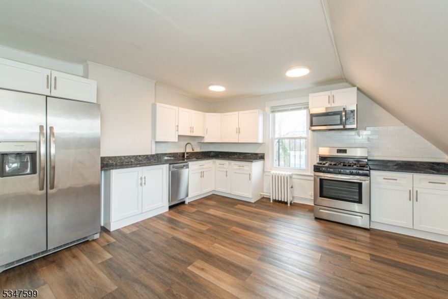 Location, Location, Location! This affordable top floor 3 bedroom, 1 full bath unit is one block from the heart of Downtown Summit & Weekly Farmer's Market. Unit is complete with a large updated kitchen with granite countertops, SS appliances, chair rail moldings, laminate flooring throughout and skylights which bring in natural lighting. High efficiency whisper quiet window AC units are provided in every room - enjoy the benefits of public utilities and natural gas! This home is a commuter's dream, close to major highways and Newark airport, as well as Restaurants, Shopping, Entertainment and walking distance to Train Station where you can catch the Midtown Direct Line to NYC.