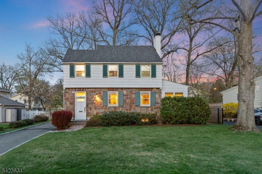 STORYBOOK SIDE HALL COLONIAL IN THE HEART OF SPECTACULAR SUMMIT! Steps from Tatlock Field & Washington Elementary, 128 Canoe Brook is a 3 Bedroom, 2.1 Bath home that exudes warmth and character. A fully fenced yard wraps this gem like a gift, promising peace and privacy! An elegant French door welcomes you inside the Entry Foyer and into the Living Room anchored by fully functioning classic wood-burning red brick fireplace, plus crisp shelving ready to cradle your favorite novels and keepsakes. Natural light floods the brilliantly bright Sunroom, where motorized window treatments let you command the ambiance at a button's touch, while you dream up your next big idea in possible Home Office, or simply relax at the end of a long day. Dining Room delights w/ refined chair rail molding and modern pendant light adding timeless dimension. Curated Kitchen impresses w/ stainless steel appliances, and direct access to stunning new Timbertech deck for seamless interior-exterior living. Upstairs, 3 Bedrooms bask in natural light, w/ each boasting generous closets. Primary Suite pampers w/ Ensuite Bath including large linen closet that organizers dream about. Finished Lower Level Recreation Room is ready for fun and social gatherings w/ sleek, space-saving custom bar nook. And then there's Summit itself, w/ extraordinary schools, effortless NYC commute, and dining scene that punches well above its weight! Just blocks to Morris Ave shops and only minutes from the Sunday Farmers Market!