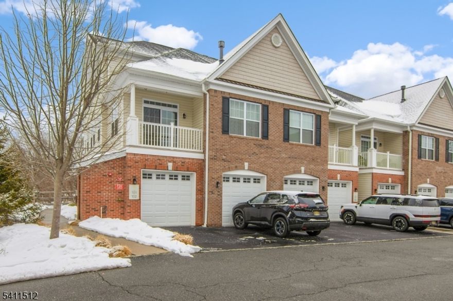 Stunning newer end unit townhouse in desirable Autumn Pointe, built in 2018, offering three levels of upgraded living space enhanced by the original owner. Large windows throughout this corner unit fill the home with natural light. Enter through a welcoming foyer with hardwood stairs leading to the main level, featuring two closets and a powder room. The open living and dining area boasts a soaring cathedral ceiling, highlighted by a gas fireplace. French doors open to a spacious balcony overlooking a beautiful scenic view, perfect for morning coffee or evening gatherings. The bright white kitchen features stainless steel appliances, including a two year old refrigerator, white quartz countertops, subway tile backsplash, breakfast bar, and large pantry closet. The third floor offers a den overlooking the main level with a computer nook and potential for a third bedroom, as closet space already exists. The primary suite features a tray ceiling, walk in closet, and river views from the bedroom, with an ensuite bath offering a double quartz vanity, stall shower with quartz seat and glass door, and a linen closet. A full hall bath includes a granite vanity. The laundry room with full size washer and dryer also serves as a utility room. 2 zone Heat/CA. Convenient access to a deep one car garage with storage area and electric door. Close to NYC transportation, including Little Falls train station, and Montclair shopping and dining.