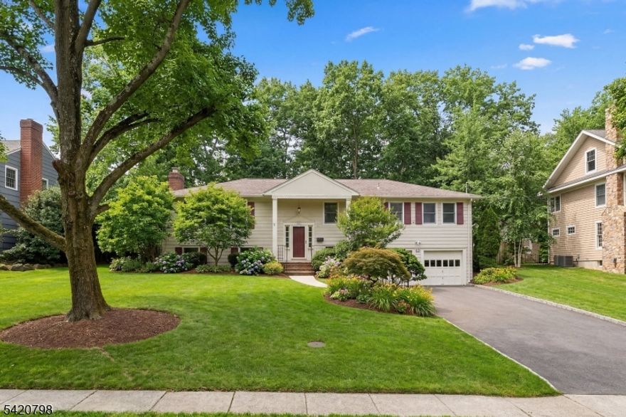 Set on a quiet residential street in the Indian Forest neighborhood of Westfield, this spacious 4 bedroom, two full-bath, two half-bath bi-level home offers a wonderful blend of comfort, space, and convenience. The rear of the property overlooks a private wooded area, creating a serene backdrop for the patio and al fresco dining area just outside both the kitchen door and the dining room's double French doors. The spacious rooms provide great spaces for loved ones to gather.The large eat-in kitchen is a standout, featuring skylights, cathedral windows overlooking the backyard, high-end appliances, two separate sinks, a center island with seating, pantry and storage closets, and a built-in hutch/cabinetry area. Just off the kitchen, the adjoining media room includes built-in cabinetry for a TV and sound system.The primary suite provides a private retreat, with large bedroom, hallway leading to a large walk-in closet, second closet, and the entrance to the spacious ensuite bath. The bath includes cathedral ceiling, skylight, double sinks, an oversized stall shower, soaking Jacuzzi tub, multiple storage closets, a large window.. Additional highlights include a Jack and Jill bath, powder rooms on both floors, attached 2-car garage, and whole house generator. Hardwood floors run throughout much of the first floor.Ideally located near a lovely town park, direct NYC bus line, Westfield train service, wonderful schools, downtown shops and restaurants.
