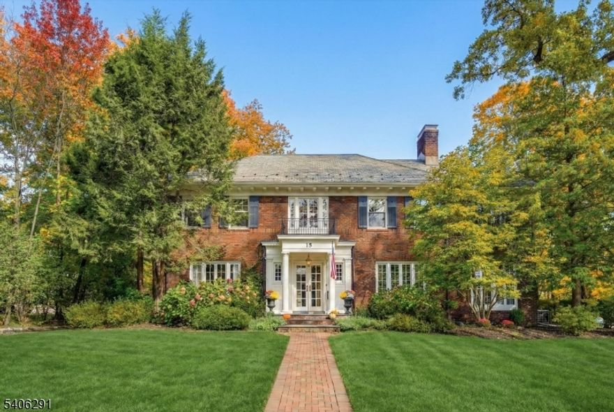 Set high on a gentle hill, this stately brick Colonial blends timeless architecture w/ a warm, welcoming interior designed for modern living. A gracious foyer w/ 3 closets including the original phone closet sets the tone. The sun-filled living rm features a gas fireplace, custom built-ins, & original French windows & doors that open to a cozy den w/ add'l built-ins & a seamless blend of original charm & newer Pella windows.The chef's kitchen is both refined & functional, offering Bosch & Viking stainless steel appliances, quartz countertops, instant hot & filtered water, a spacious food pantry & a cleverly tucked-away under-stair pet station. A butler's pantry w/ cherry counters & beverage fridge connects beautifully to the formal dining spaces, while a thoughtfully designed mudrm w/ built-in cubbies keeps daily life organized. A classic laundry chute adds character & convenience. The primary suite offers a private retreat w/ en-suite bath, walk-in closet & flexible "cloffice. 4 add'l bedrooms & a Jack-and-Jill bath provide exceptional versatility. A walk-up attic w/ exciting future potential. The finished lower level expands living space w/ a lrg rec room, pwdr rm, laundry rm, wine storage, toy closet & ample utility storage. A rare opportunity to own a classic brick Colonial moments from GR's top-rated schools, the NYC direct train & neighborhood favorites like Fitzgerald's & Starbucks, the location is as exceptional as the home itself.