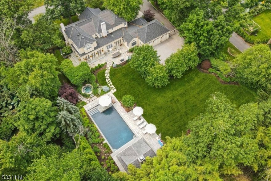 STUNNING SHORT HILLS COLONIAL * PRIME LOCATION * Welcome to one of the most exceptional estates in Short Hills. This stately Colonial blends timeless architecture with modern sophistication and sits atop expansive, beautifully landscaped property--it is designed for luxurious living & effortless entertaining. Walk up the front path and step into the gracious foyer to find refined living and dining rooms filled w/ natural light and elegant detail. The sun-soaked family room and chef's kitchen boast floor-to-ceiling French doors offering breathtaking views of the sprawling rear lawns, seamlessly connecting indoor & outdoor spaces. The gourmet kitchen is a culinary masterpiece, featuring sleek cabinetry, high-end appliances, center island & walk-in pantry. A 1st flr office, bedroom, full bath, mudroom & heated 3-car garage provide convenience & flexibility. Upstairs, the luxurious primary suite is a true retreat w/ a sitting area, office, two custom closets & a spa-like bath. LL: recreation, wine cellar & fitness. Step outside to an entertainer's dream: resort-style pool, hot tub, pool cabana w/ fireplace, bar & bath w/ outdoor shower and tranquil pergola. Ideal location: just blocks to top-rated schools (Glenwood 0.8 mi), MMS (0.7), MHS (0.7) & Short Hills train station (0.2mi). Crafted with meticulous attention to detail and filled with luxury finishes throughout, this is a rare opportunity to own an exquisite home on fabulous property in a friendly & convenient neighborhood.