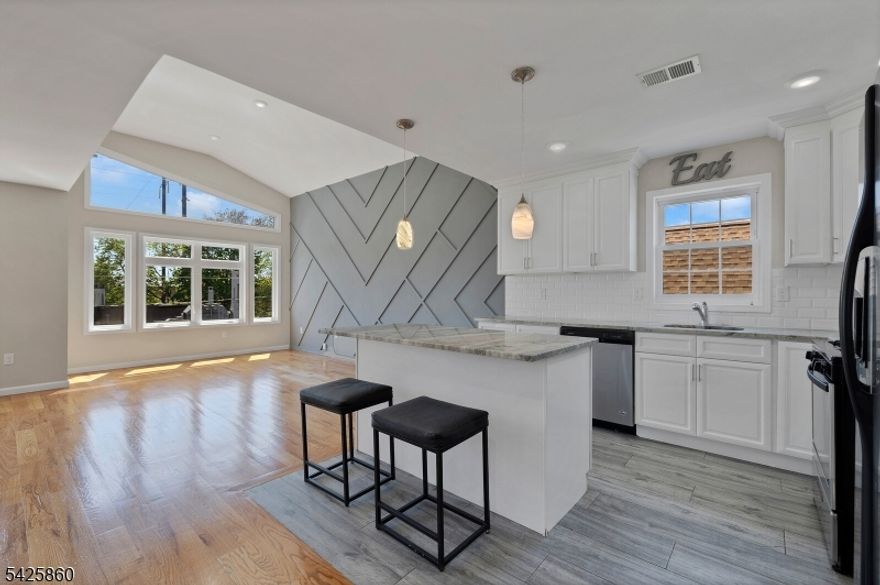 This is your dream home either to live or to invest. ALL NEW 2 family units each one with 3 bedrooms and 2 baths, plus bonus rec. room on slab basement. The units have ana amazing open concept dining living room, beautiful quartz center island, large windows, vaulted ceilings, hardwood floors, through out, 2 HVAC system, tandem garage 2 cars, plus bonus rec room behind. LOCATION is premium walkable to everything. Accessible to public transportation.  Few minutes from Penn Station, very accessible to 1&9 Highway. Property will be delivery vacant!