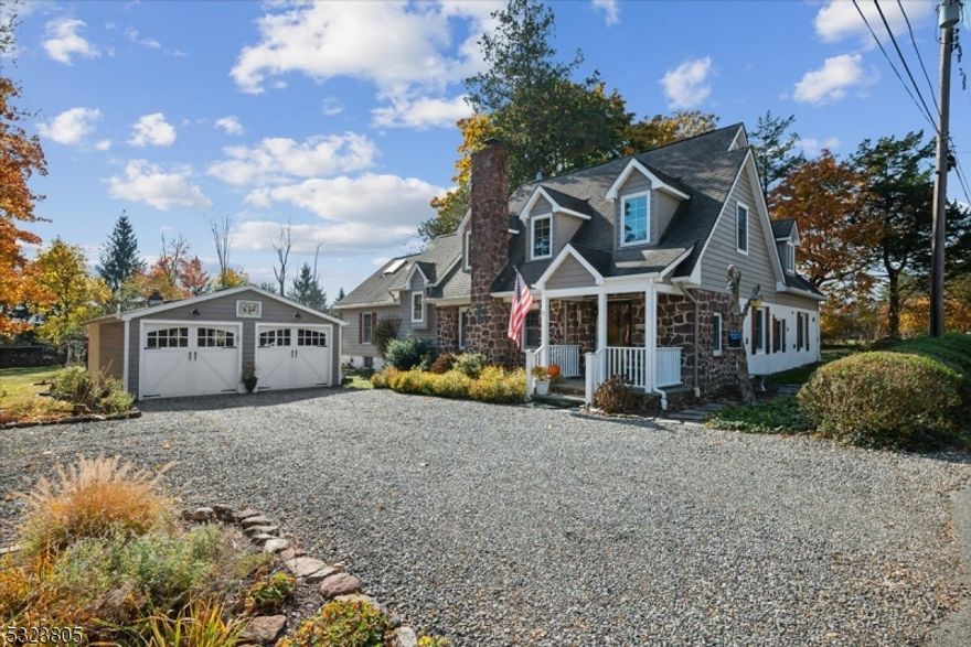 Warm & Welcoming Gem in a Bucolic Setting. Set on 0.75 acres in Chester Township, this custom expanded Cape blends country charm with modern convenience. Step into this stone home, where hand-hewn beams frame the entry to the main level. Gleaming hardwoods and recessed lighting create a cozy ambiance, highlighted by a stone fireplace with a Vermont Castings wood-burning stove in the living room. This inviting space, with custom built-ins, flows into the kitchen, breakfast nook, and dining room, all bathed in natural light. The updated kitchen features rich wood cabinetry, granite countertops, Bosch stainless steel appliances, and a spacious center island. Adjacent, the dining room has a vaulted ceiling, skylights, and sliding doors opening to the backyard. Off the living room, French doors reveal a quaint nook for reading or music, while a library/office with custom built-ins and private entry offers a quiet retreat. The main-floor primary bedroom includes two closets and a large en-suite bath with dual vanity, walk-in shower, and jetted tub, plus a half bath in the hall. Upstairs, find three bedrooms, a sitting room, and a full bath with dual vanity. Laundry and storage are in the basement. Outdoor entertaining is easy with two decks, a sprawling backyard, firepit, and storage shed. Detached two-car garage/workshop. Nestled in a quiet cul-de-sac, with top-rated schools, including IB certified High School, shopping, dining, and NJ Transit minutes away in downtown Gladstone.