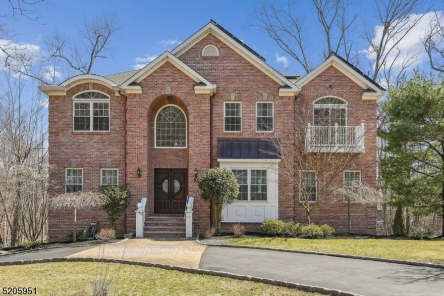 This gorgeous 5 bedroom + home office, 4 bathroom, brick front Colonial home with approx4,000SF plus 1100SF finished walk-out basement is situated on a beautiful, tree lined street with cul-de-sac on 0.57 acres. It features a 2 story grand entry foyer with motorized Georgian Court chandelier, 9 ft ceilings on the main level, and an open concept floor plan. Large kitchen is complete with a center island, walk-in pantry, custom cabinets, Brazilian cold spring granite counters, SS appliances, and double ovens. The sun-filled breakfast area has a sliding door w/transom windows leading to a large deck overlooking the park-like backyard, Formal dining room w/ tray ceiling, Family room w/ gas fireplace, Palladium windows, tray ceiling. 2nd level consists of 4 beds, 3 baths, Primary Bedroom w/ cathedral ceiling, seating area w/ decorative post and sliding door to Juliet balcony, dual walk-in closets & spa-like bath w/ jetted tub, stall shower, steam, dual sinks vanity & private toilet room, 2nd bedroom w/ en-suite bath, bedrooms 3 & 4 with Jack n Jill bath and walk in closets. Finished walk out basement offers a recreation room w/ a built-in dry bar and slides to a large patio in the rear yard, media room w/ wine closet. Other fabulous features include hardwood floors & recessed lighting throughout, crown moldings, ceiling fans in every bedroom, mahogany double entry door, circular driveway, solar energy system providing clean power and reduced energy bills, and copious storage space