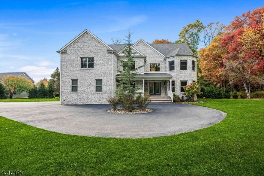 Nestled on over an acre and surrounded by preserved farmland, this stunning custom-built Colonial offers more than 5,000 square feet of elegant living space across three levels. Designed with both comfort and sophistication in mind, the home features five spacious bedrooms - each with a private en-suite bathroom - including a first-floor in-law suite. The modern gourmet kitchen is a chef's dream with Thermador & LG appliances, complete with a center island, large pantry w organizers, quartz countertops and stainless-steel appliances. Additional highlights include hand scraped maple hardwood floors, throughout, custom window treatments, a remote-controlled chandelier and closet organizers in every closet for optimal storage. The finished basement with a full bathroom offers versatile space for recreation or relaxation and includes a wall of built in closets and two tankless hot water heaters for year-round comfort and efficiency. A covered front porch and circular driveway lead to a three-car finished garage with built-in cabinetry. The expansive Cambridge stone paver patio, complete with a knee wall and bult in fire pit, creates the perfect setting for entertaining or peaceful evenings under the stars.