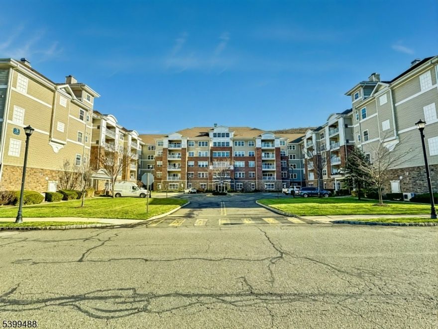 Wonderful 1st floor condo at Wanaque Reserve that has a 24 hour gated 55+ community with a scenic private location with wonderful park like views. This spacious 1768 square foot Colfax model offers 3 elevators per building, an open-concept living, a light-filled living room and kitchen with double sliding glass doors leading to a private balcony. Spacious formal dining room for entertaining, loads of natural sunlight, and the bonus office/guest room with French doors. Primary bedroom is a suite with a large walk-in closet and separate dressing area. Set on 435 acres, Wanaque Reserve offers a 20,000 sq. ft. clubhouse with indoor/outdoor pools, a fitness center, theater, sauna, tennis & bocce courts, walking trails, and more. A Must See!