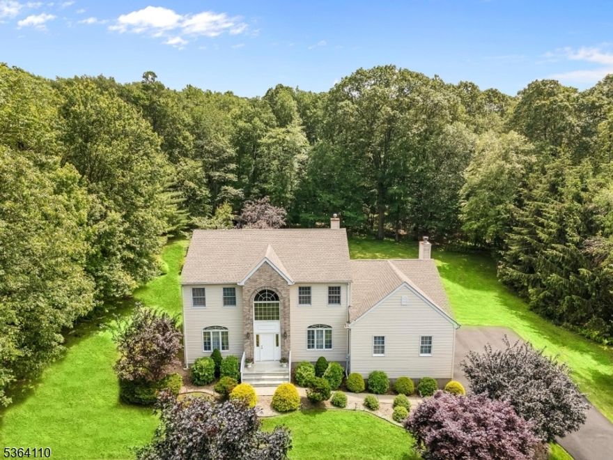 Impeccably maintained center hall colonial on Schoolhouse Estates cul de sac offers the perfect lifestyle for those looking to escape the hustle and bustle of everyday life.  This beautiful colonial is situated on a lovely tree-lined street on just under an acre of level and usable property, backing to woods for privacy and includes tranquil garden and gazebo, landscape pathway lights and modern landscape.  Features include spacious, sunlit rooms with hardwood flooring, gracious two-story foyer, updated eat-in kitchen with granite countertops, center island/breakfast bar, stainless steel appliances, recessed lighting, wine and coffee bar, step-down family room with wood burning fireplace, formal living and dining rooms and first floor office!  Second floor offers double door entry to primary suite with tray ceiling, giant walk-in closet and luxurious bath with jetted tub and stall shower.  Three additional bedrooms and full bath complete the second floor.  Partially finished basement has access to garage for storing off season outdoor equipment and furniture.  Other highlights include brand new HVAC, 4 year old roof, thermal windows, natural gas heat, outdoor patio for entertaining, recently re-paved driveway, refurbished front steps with new railings and tremendous "shed" storage under family room accessible from driveway.  Move in ready, close to schools and minutes to shopping, dining, Routes 206,46 and 80.  Fantastic Mt. Olive Schools!