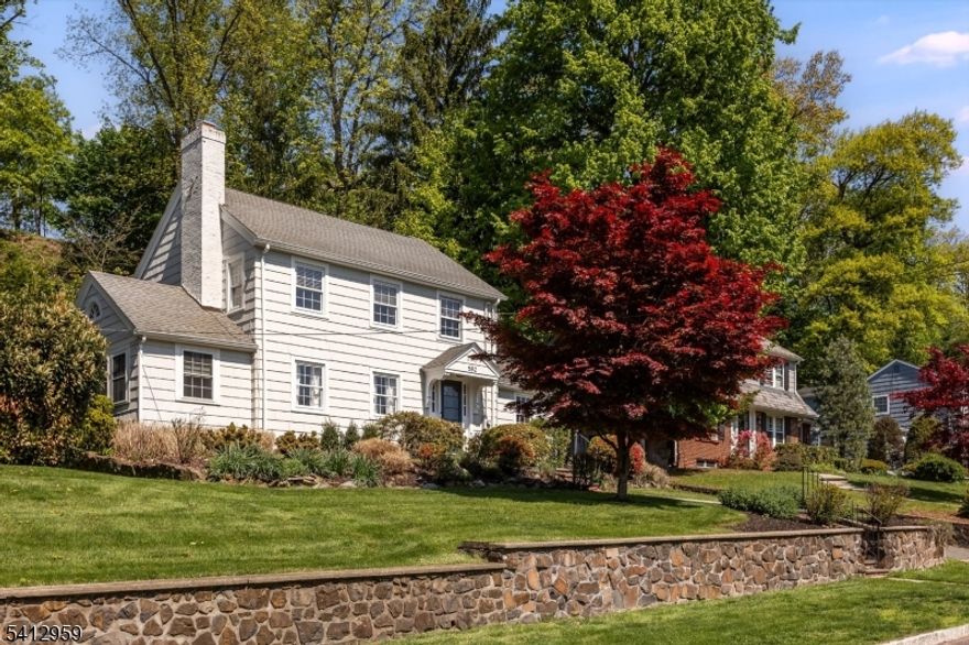 Set in a highly sought-after Upper Montclair location, this classic 3-bedroom Colonial offers the ideal combination of character, updates, and everyday livability, just minutes from the Montclair Heights train station. With direct access to NYC transit only moments away, this is a true commuter's opportunity. Inside, the home blends timeless details with thoughtful improvements. The renovated kitchen features a Viking 6-burner range, SubZero refrigerator, Bosch dishwasher, custom cabinetry, and freshly refinished granite countertops, enhanced by a skylight and new dimmable LED lighting. The main level flows easily between living and dining spaces, highlighted by a beautifully maintained original brick fireplace and built-in cabinetry. A sunroom / flexible office space provide options for work-from-home or additional living areas. Upstairs offers three well-proportioned bedrooms, including a spacious primary with two closets, and a full bath with Kohler fixtures and marble finishes. The finished lower level adds a bonus space with room for recreation, fitness, or storage, along with laundry and walk-out access. Outside, the deep, backyard with bluestone patio, irrigation system, and mature landscaping offers the perfect outdoor setting. Additional features include 2-zone central air, a split system for supplemental cooling, a built in garage with loft space, and numerous system updates. Bringing together location, convenience, and everyday ease, 582 Highland is a must see!--