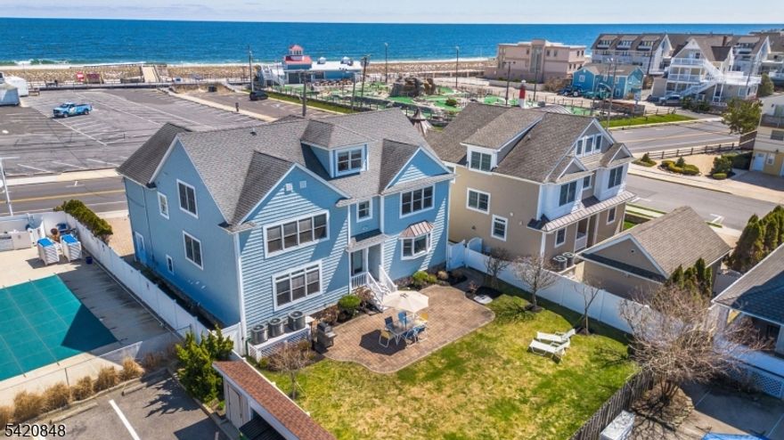 Experience a rare opportunity to own a premier coastal investment property, offering a front-row seat to the Jersey shore. This beautiful home effortlessly provides modern comfort, featuring 6 bedrooms and 6 bathrooms, where every bedroom conveniently has its own ensuite. Hardwood floors, wainscoting and crown molding throughout the house. First floor has 9ft ceilings. The third floor has an expansive loft with a full bath. The heart of the residence is a stunning gourmet kitchen designed for grand entertaining, with a center island, granite countertops, Viking package stainless steel appliances and a wine fridge. The open floor plan is perfect for entertaining. The master suite impresses with high vaulted ceilings, a luxurious bathroom with a built-in Jacuzzi and a private balcony overlooking Jenkinson's Beach. Designed for seamless living and peace of mind, the home is outfitted with an alarm system, a built-in music/intercom system and storm windows. Also included are a tankless water-heater and central vacuum. Significant upgrades include new HVAC units installed in both 2022 and 2025. Outside, discover a private backyard and patio, complete with an outdoor shower.  This home offers unbeatable access to the vibrant beach and boardwalk scene.