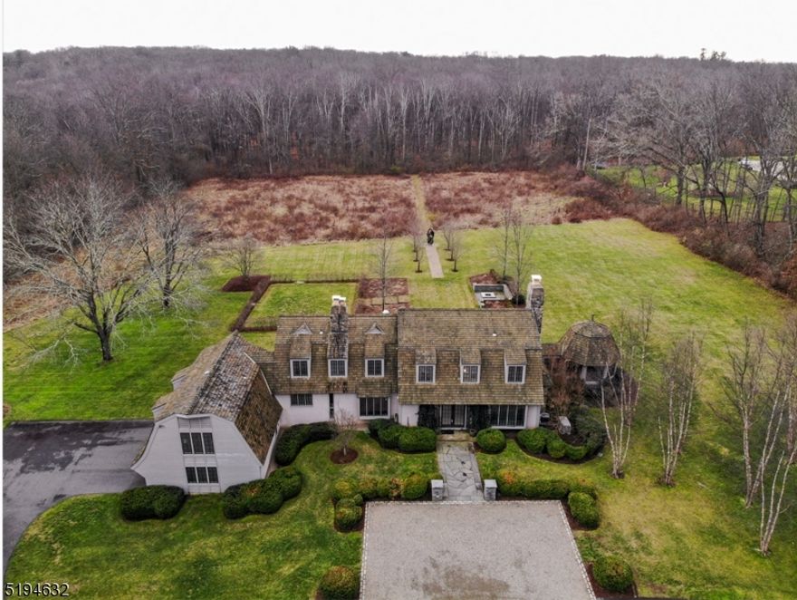 Located in sought after Harding Township, this majestic estate is located on 6 level acres that is both landscaped and backs up to a wooded area at the end of a cul de sac. This lovely house, reminiscent of an English manor has 5 bedrooms with 5 full baths and 1 half bath. The formal living room running from the front of the house to the back of the house has a large, open, wood burning fireplace that creates an enchanting and cozy place to relax. The formal dining room opens out to a blue slate patio overlooking the remarkable property. The gourmet kitchen has stainless steel appliances, a ar/butler's pantry area open to the 2 story family room with a second wood burning fireplace. The second level contains 5 bedrooms, two of which share a Jack and Jill bathroom. A third bedroom ensuite is the perfect place for guests. The fourth bedroom is next to a hall bath. The master suite contains a bathroom with separate shower and tub with walk in closet and dressing room. The lower level has a walk out mud room or built in pool house (for a future pool) with full bath. Below that is another walk out lower level perfect for a gym, office or entertaining. Low Harding taxes! A must see!