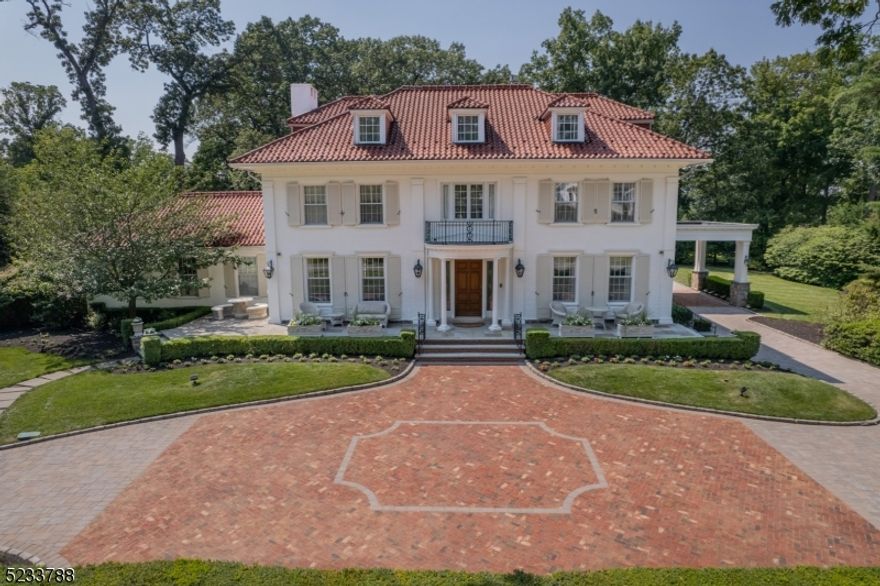 Grand & Elegant Center Hall Colonial offering 5BR, 5BA & 2 ½ BA on over an acre of meticulously manicured grounds. This large level lot is ideally located on a very desirable street in the Borough of Essex Fells. Classically designed & fully renovated, this home features tremendous craftsmanship & is move-in ready! The moment you arrive, you are greeted w/ a large circular brick paver driveway that includes radiant heat & leads to an oversized 4 car garage. Upon entering the grand foyer, you are welcomed w/ a 3-tiered staircase & mahogany pocket doors leading to the formal Dining Room & Living Room. The luxury kitchen features a large center island, imported Marble counter tops & high-end appliances. The family room includes a custom wet bar w/ walk out French doors to the patio. 2nd FL contains 4BR/3BA, gym w/ sauna, custom built-in office & 2nd laundry room. 3rd FL is a full floor BR w/ large living space, exposed brick wall, custom BA & walk-in closet. Other notable features are the award-winning 2.5k bottle wine cellar, memorabilia/library room & fully finished walk out basement. The outside areas have elegance to match the rest of the home w/ a custom waterfall feature, wood burning fireplace, kitchen w/ sink, grill, pizza oven & separate beverage center, 2 full home generators, 8-seater jacuzzi & Spanish tile roof w/ snow guards. This home is truly one of a kind and offers every modern-day amenity while maintaining old world charm.