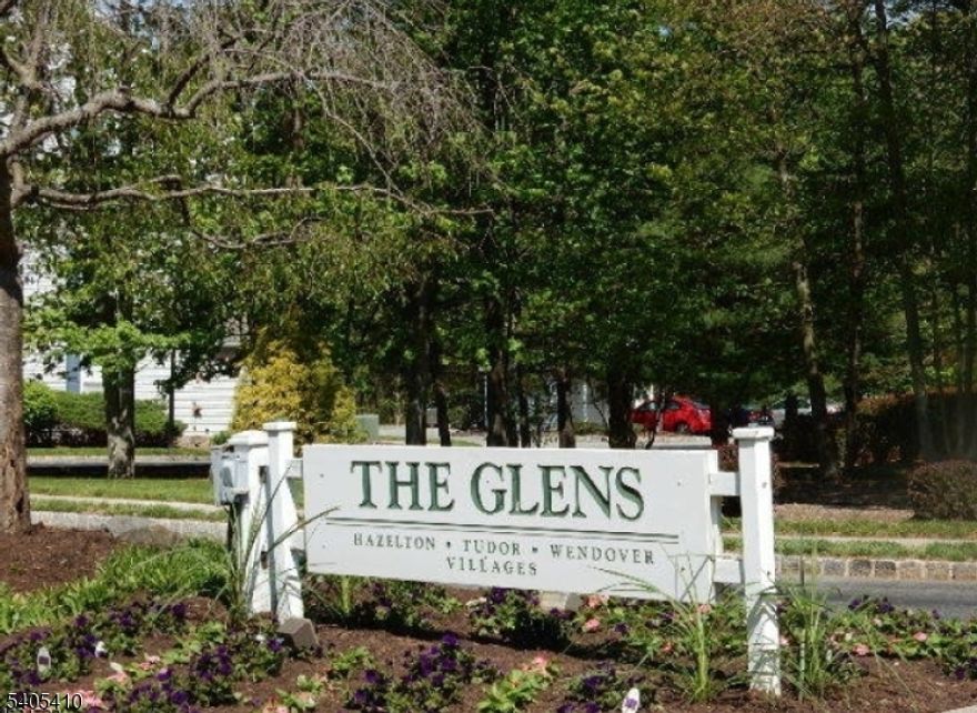 Check out this totally move-in ready first floor condo  tucked away in a quiet corner of the The  Glens Community.  Entryway is start of trendy flooring throughout.  The bright  white updated kitchen has  great counterspace, microwave oven over gas range, stainless refrigerator and dishwasher.  It features convenience  to combo pantry closet/laundry.  Dining Room is open to both Kitchen and Living Room.  Bathroom redo just completed..  Windows galore let in beautiful light .  Stylish blinds for altering the mood.  Find Closets in entry, plus hallway walk-in closet, double closet in BR, linen closet in bathroom. Enjoy the outdoors and treed  yard from your private patio. It's right outside your Dining Room door.  This easy access, no steps  unit offers  a Lifestyle that includes  community pools in two separate locations, clubhouse, tennis courts, playground.  Set your furniture down and begin to live the life!!!