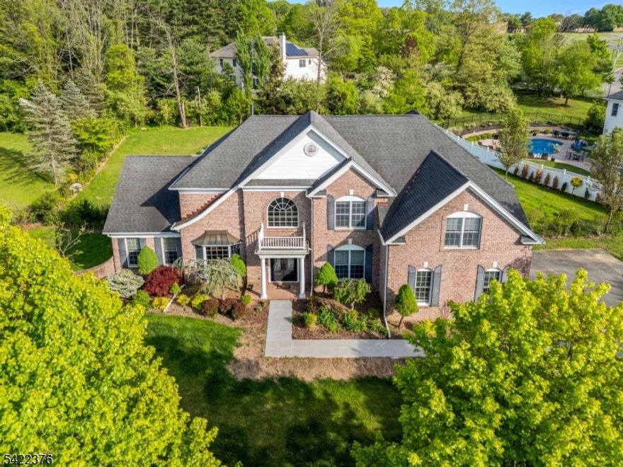 Crafted with care, nestled in a picturesque cul-de-sac, this stunning luxurious colonial home offers timeless elegance with a modern twist. From the moment you step into the grand new steel doors and newly renovated entrance with gleaming floors, you're greeted by soaring ceilings and light-drenched spaces enhanced by countless windows throughout. The heart of the home is the newly upgraded kitchen, a true showstopper, featuring a Spanish-imported quartz waterfall kitchen island, top-of-the-line appliances, and an adjoining breakfast sunroom that's perfect for morning coffee or weekend brunches. The gorgeous dining room has an adjacent gathering room with a gorgeous wall of windows sure to leave a grand impression. The spacious family room boasts dramatic high ceilings and a cozy floor to ceiling fireplace, creating an inviting space for gatherings. Upstairs, discover a Jack and Jill suite, a charming princess suite with a private full bath, and a lavish primary suite complete with a walk-in closet, elegant tray ceilings, and its own fireplace your personal retreat after a long day. The fully finished basement adds a generous amount of additional living space, perfect for entertainment, quiet office space or just relaxation. Outside, the private backyard oasis offers lush landscaping, a tranquil garden area, and serene privacy ideal for unwinding or hosting under the stars. This is the perfect blend of classic charm and modern luxury designed for unforgettable gatherings.