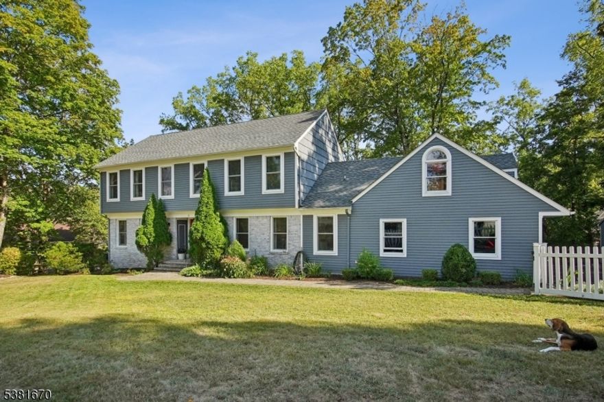 This welcoming four-bedroom, two-and-a-half bath Center Hall Colonial is designed with everyday living and family comfort in mind. The spacious living room, complete with charming built-ins, is perfect for gathering, while the large, updated kitchen offers plenty of room to cook, connect, and enjoy meals together. Just off the kitchen, access to the deck, a laundry room, and direct garage access add everyday convenience. The cozy family room, highlighted by a raised brick hearth fireplace also opens to the deck and patio and are ideal for summer barbecues, playtime, and relaxing outdoors. Upstairs are four comfortable bedrooms and two full baths, including a primary suite with its own beautifully updated bath and walk-in closet. The additional hall bath has also been thoughtfully renovated. A partially finished lower level provides extra space for a playroom, home office, or media area. Located just minutes from the elementary school, municipal pool, tennis courts, and sports fields, this home also offers easy access to downtown Morristown, where you can enjoy great shopping, dining, coffee spots, the MPAC Performing Arts Center, and MidTown Direct train and bus service to New York City! With a whole-house Generac generator, newer windows, updated kitchen, and baths, this home is move-in ready!