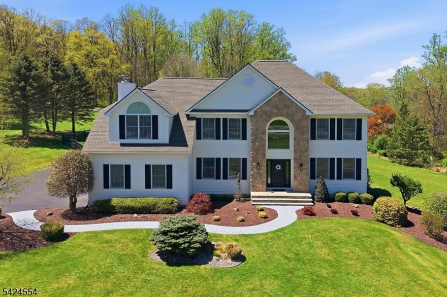 Exceptional Center Hall Colonial with awesome views and a Valley location!  This home is set above the street on a 3 plus Acre lot.  The 1st floor offers wood floors, 9ft ceilings with a 2 story foyer and cathedral ceilings in the family room.  The updated kitchen offers quartz counter tops, tiled back splash and stainless appliances.  The kitchen opens to the family room with a wood burning insert fireplace.  Upstairs offers wood floors, a large primary suite with a walk-in closet, 3 additional well sized bedrooms and an upstairs laundry room.  The walkout basement is finished with a hangout room and a workout room.  The finished area of the basement adds approximately 1,200 sqft to bring the total sqft of the home to around 4,500 sqft.  Outside you will find a 14x33 covered deck that overlooks a meticulously landscaped yard with a  paver patio and fire-pit. The home has a 3 car garage and a 10x20 shed.  The roof was just replaced!  Califon mailing address 07830.