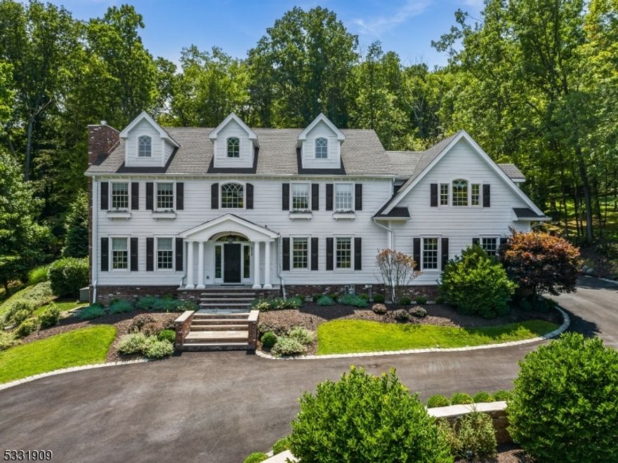This custom-built 5 bedroom 4 bathroom, 2 half bathroom Colonial Set on 1.8 acres of meticulously landscaped grounds, exudes luxury and elegance. The breathtaking two-story foyer welcomes you to the main level, which includes a library, great room with fireplace, banquet-sized dining room, powder room with custom built-ins, laundry room, and a 3-season room with a brick fireplace. The gourmet kitchen is a chef's dream, featuring a large center island, built-in refrigerator and freezer, high-end stainless steel appliances, a built-in bar, and a butler's pantry.  Separate dining area leads into the living room featuring floor to ceiling windows allowing beautiful natural light to fill the space. Retreat upstairs to discover the opulent primary suite which offers an extraordinary walk-in closet room, a spa-like bath with a soaking tub, walk-in shower, and dual custom marble vanities. The second floor also boasts 4 additional bedrooms, 2 full baths, and generous storage. A third-floor bonus room serves as a den, exercise space, or office. The fully finished basement is an entertainer's paradise, with a media room, full bar, recording room, Humidor Cigar closet, full bath, and additional storage. Outside, discover your private retreat with a custom patio, pergola, built-in fire pit, inground pool, and hot tub all backing up to the serene High Mountain Park Reserve. A paver circular driveway and attached three-car garage complete this exquisite home designed for luxurious living.