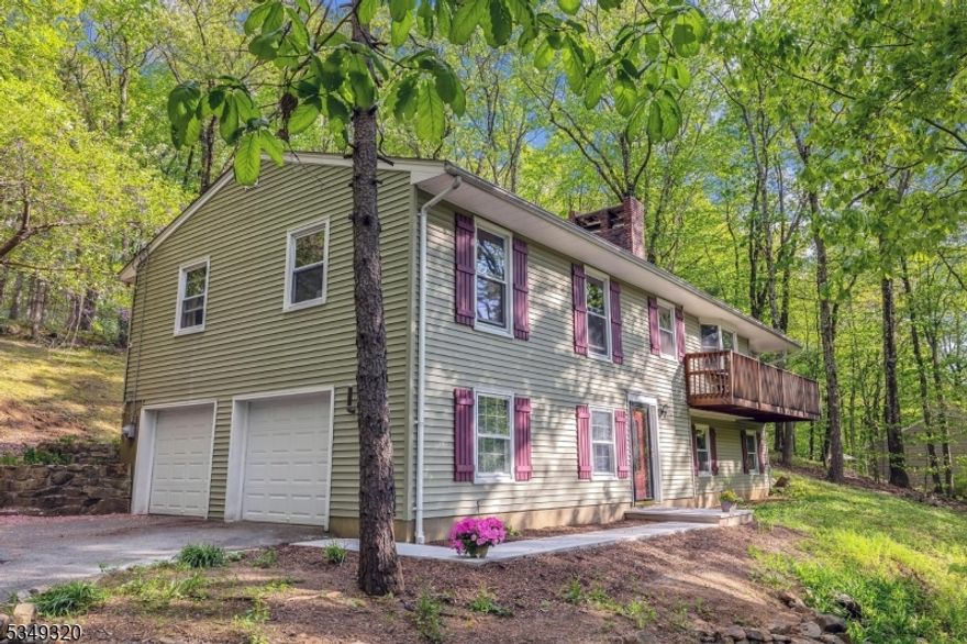 Fantastic location - cul de sac street with public water and sewer, Old Farmers Road School district, 5 minutes to Chester and easy commute to Rt. 78. Eat-in kitchen with access to private rear deck, dining room open to living room with double sided brick wood burning fireplace, sliders to front deck, 3 spacious bedrooms with main bath plus primary suite with 2 closets and full bath, hardwood floors throughout upper level. Lower level has family room with wood burning stove, laundry, foyer and access to 2 car garage. Natural gas in street. In-ground pool in woods not functional, as is.