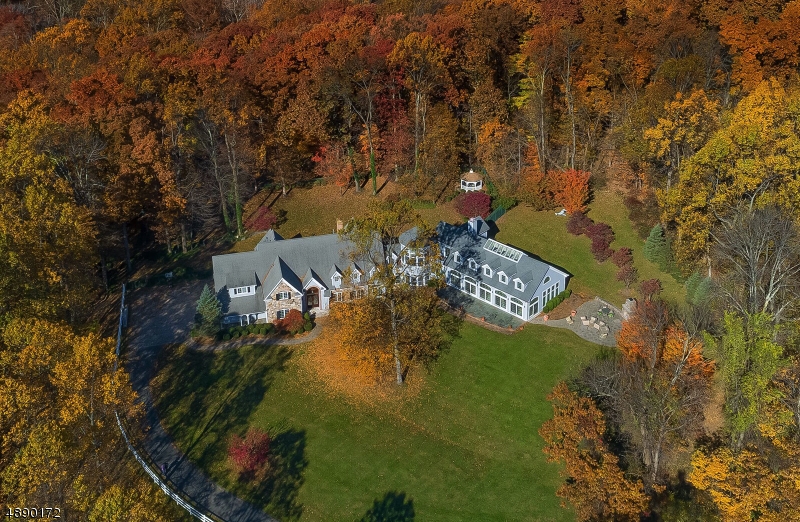 Poised on over 3 acres of manicured lawns & backing to preserved land this 7,500 sf custom built 4 bed, 4.2 bath home offers year round resort living w/ a  state-of-the-art indoor salt water pool. Located in Chester's coveted community, The Pond. This award winning custom home offers serenity and privacy with meticulously maintained rooms with tall windows and cathedral ceilings throughout to capture panoramic views.Family room with cathedral ceiling, skylights & floor to ceiling stone fireplace. A striking architectural turret with window walls of sweeping mountain views with marble inlay floors & office with custom built cabinetry. Indoor/Outdoor entertainment space with salt water pool & spa, kitchenette, full bath, loft, blue stone verandas & patio with outdoor fireplace. Finished large lower level.